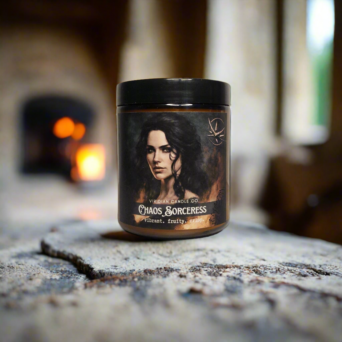 a Chaos Sorceress candle, handcrafted by Viridian Candle Co., on a concrete flagstone floor with a fireplace in the background. fantasy themed candle inspired by the Witcher.