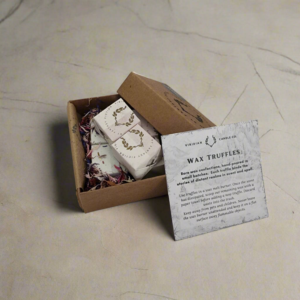 Solstice Wax Melt Discovery Box on a cement floor with six fantasy-themed wax melts individually wrapped and boxed with info card, handcrafted by Viridian Crafts Johannesburg for lovers of fantasy gifting