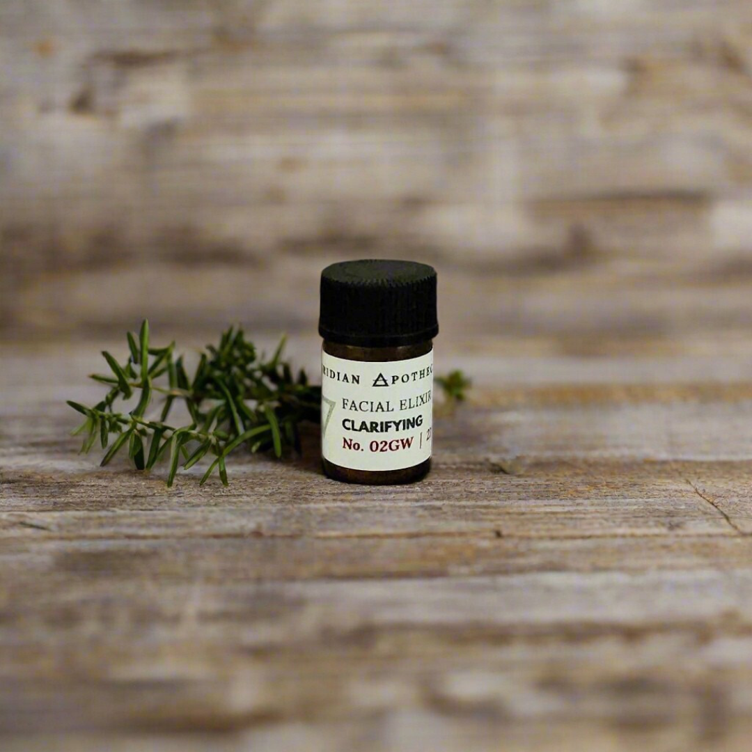 Clarifying Elixir Trial Vial by Viridian Apothecarium, on a wooden surface with a sprig of herbs