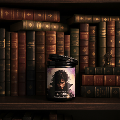 Sandman candle by Viridian Candle Co., on a bookshelf with aged books in the background.