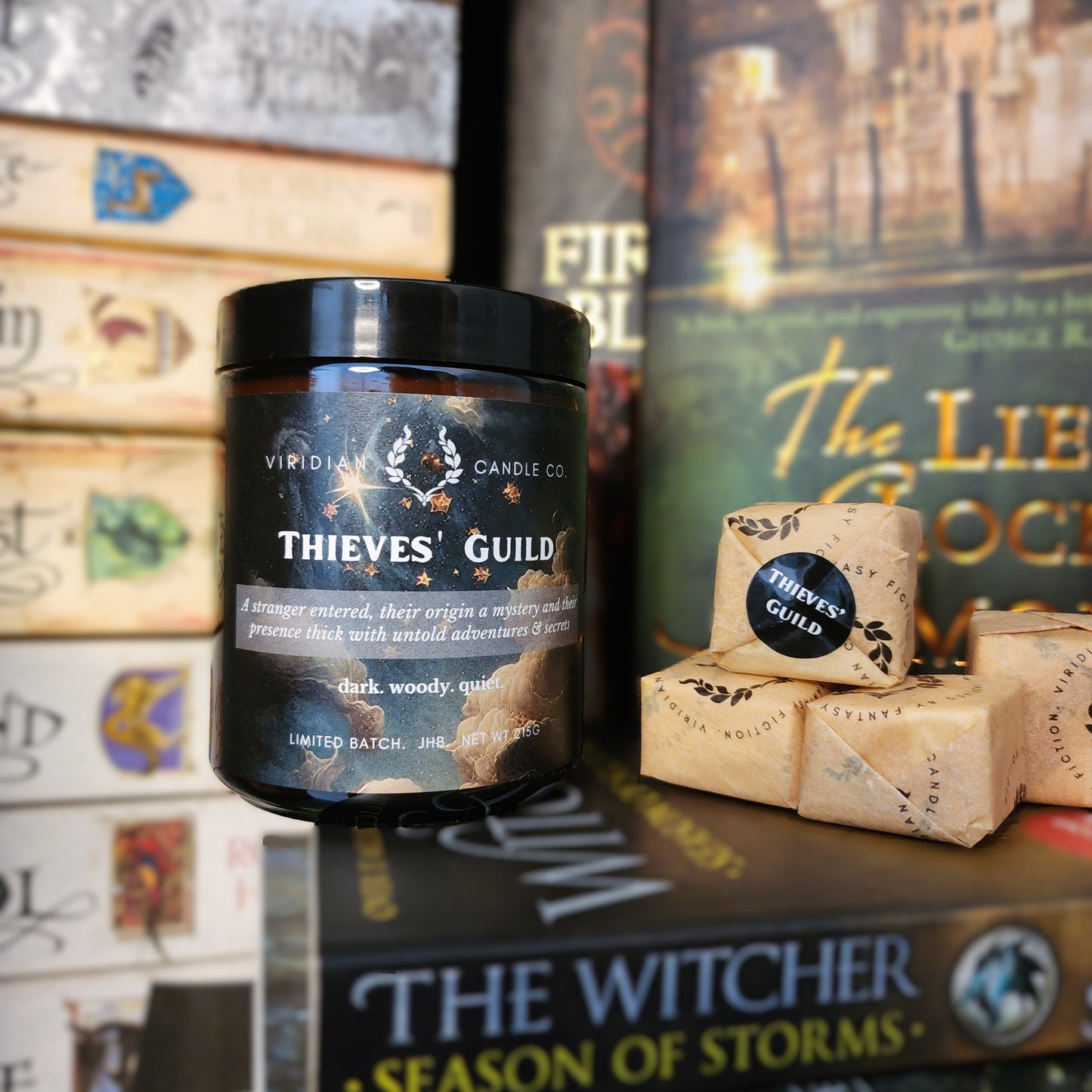 Thieves' Guild candle and wax truffle in bookcase